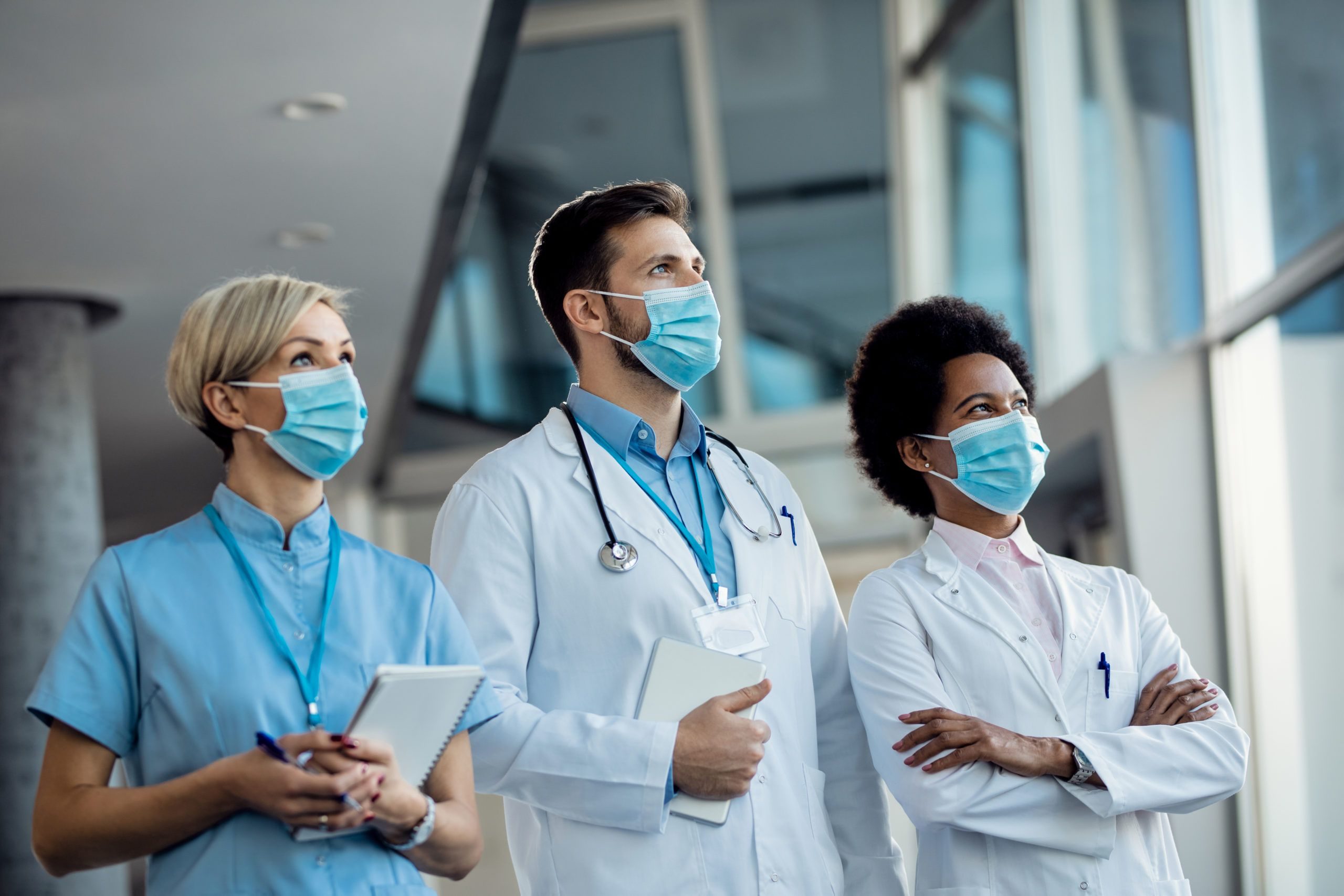 Team of medical experts with face masks at the hospital during c